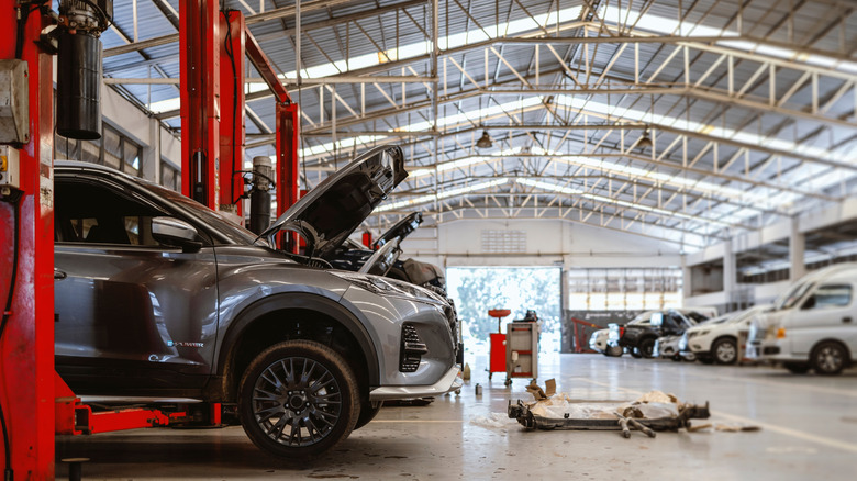 Cars in a garage on ramps, awaiting work