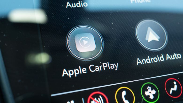 Close-up of Apple CarPlay and Android Auto logo on infotainment screen