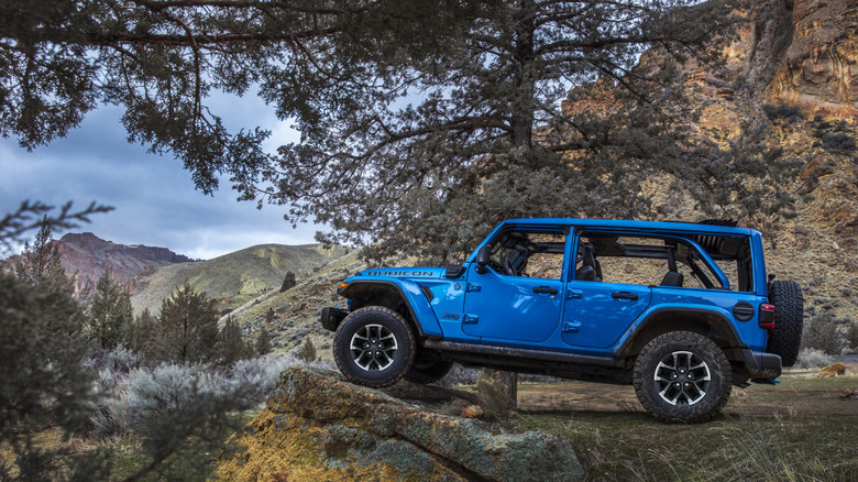 Side shot of a 2025 Jeep Wrangler 4xe Rubicon parked off-road