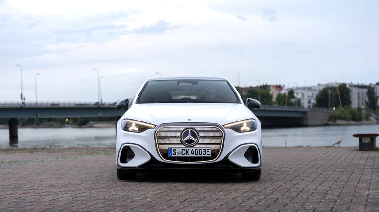 Mercedes-Benz C-Class parked near the banks of a river in a city