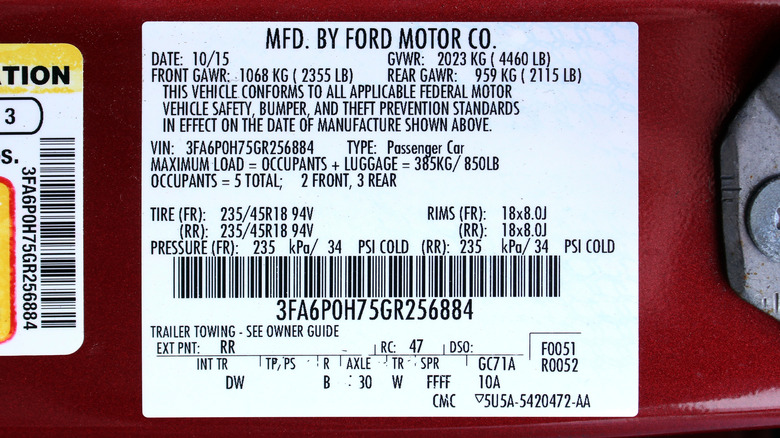 A certification label with a VIN on a driver's door jamb.