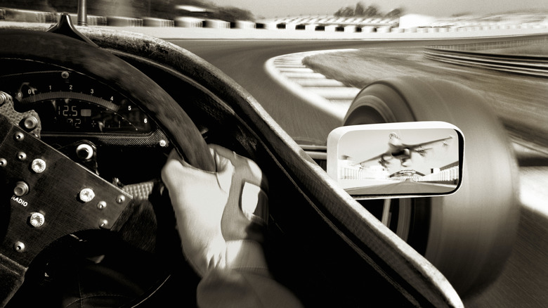 A car taking a turn on a racetrack.