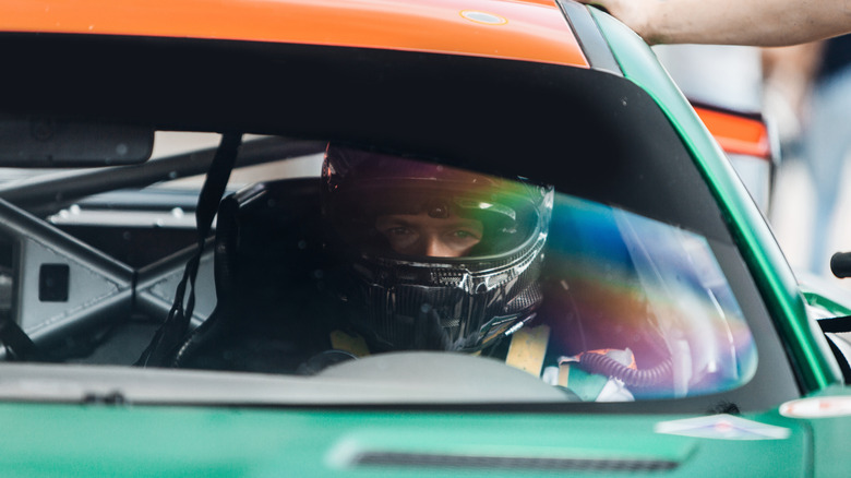 A racecar driver scanning the racetrack.