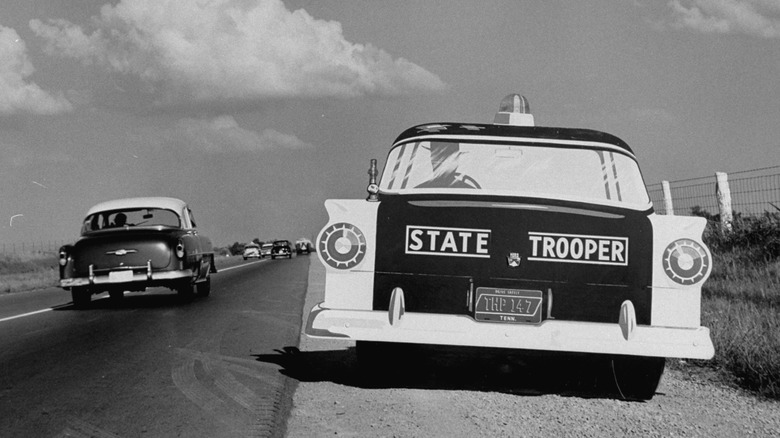 Imitation state troopers car on side of the highway to scare drivers into slowing down to cut down on accident rates.